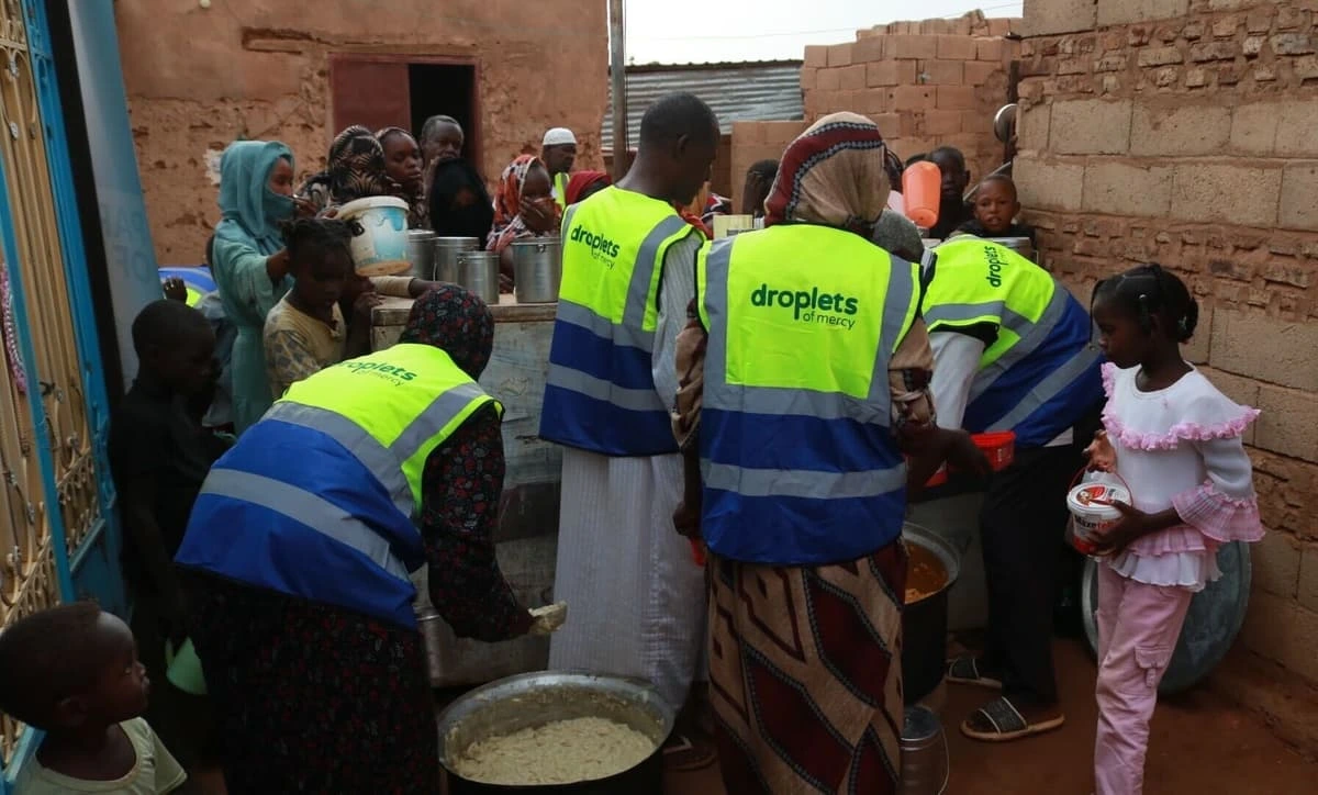 Droplets of Mercy volunteers serving food to displaced families